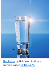 A glass of water with light reflecting the water